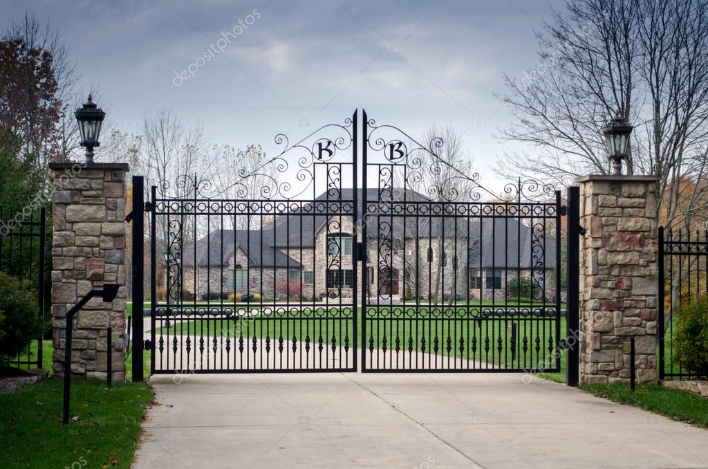 Large fancy mansion behind a gated entry